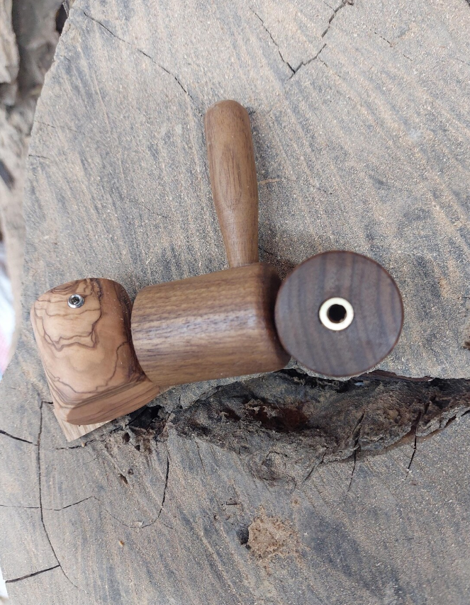 A wooden steam knob for a Gaggia espresso machine placed on a wooden surface.