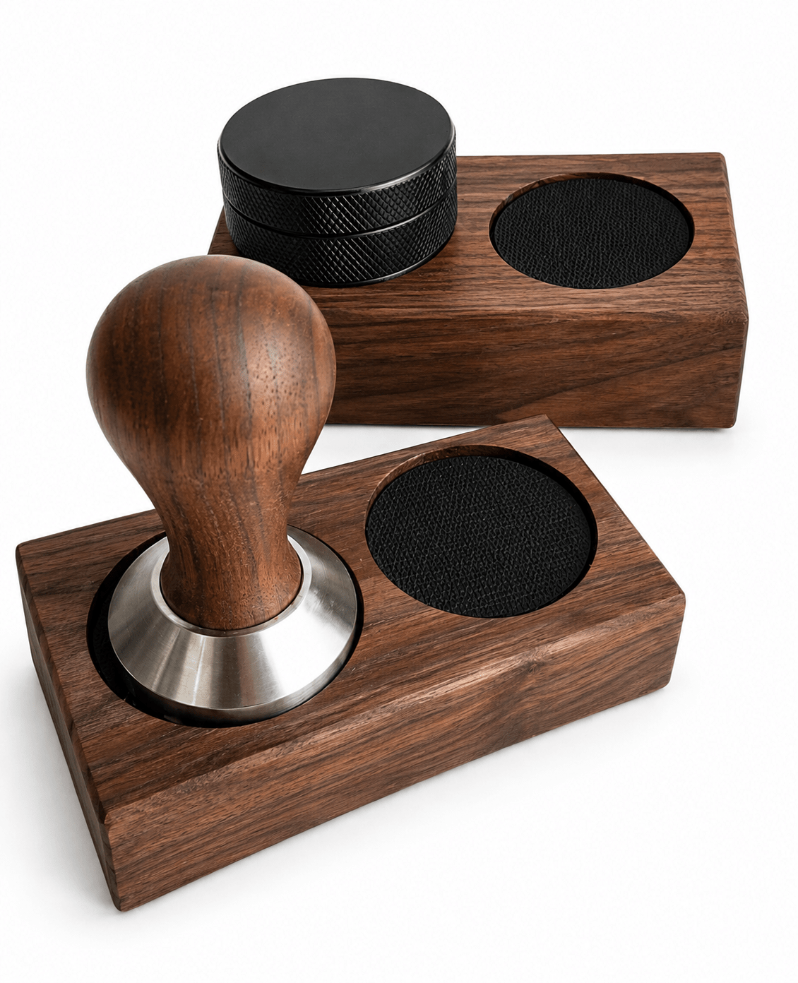Two wooden coffee tamp sets on a white background, one in the foreground with a wooden tamper handle and one in the background with a black mesh container.