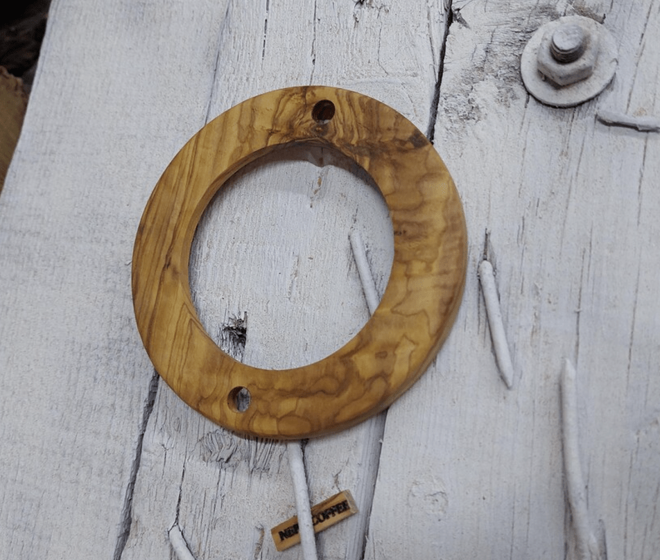  wooden collar for a DF64 coffee maker lid, placed on a white wooden surface with a screwdriver beside it.